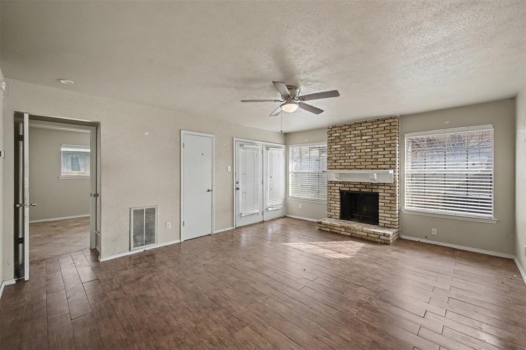 2302 18th Street Plano, TX 75074 - Photo 11 of 31 a view of an empty room with a fireplace and a window