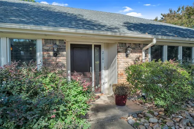 front view of a house with potted plants