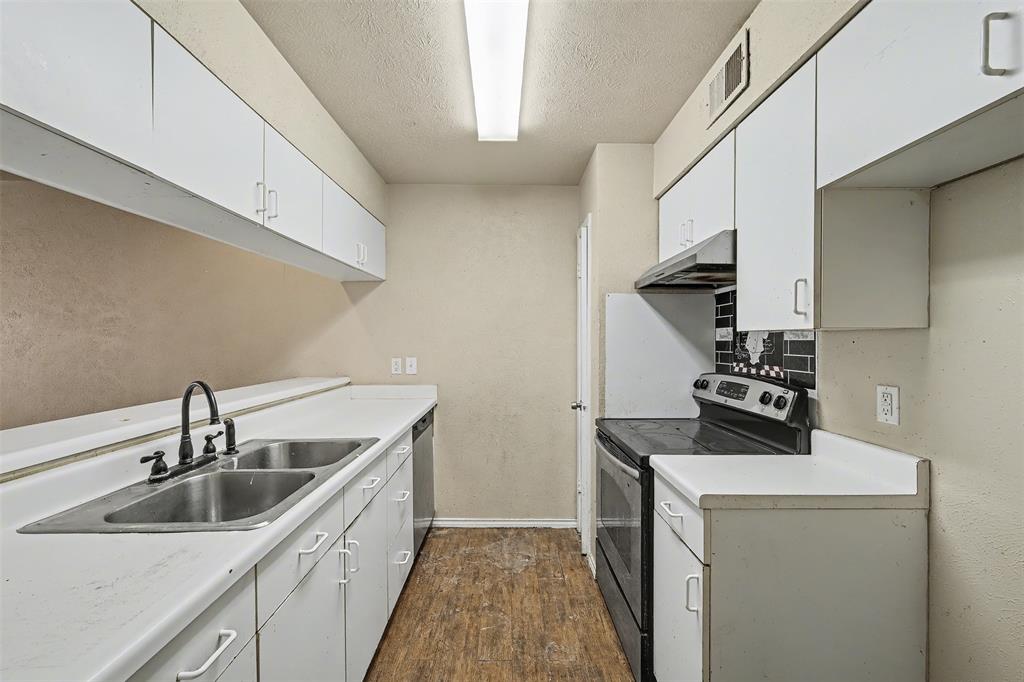 2302 18th Street Plano, TX 75074 - Photo 9 of 31 a kitchen that has a sink and a stove