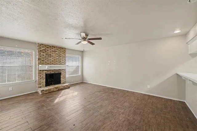 a view of a livingroom with a fireplace and window