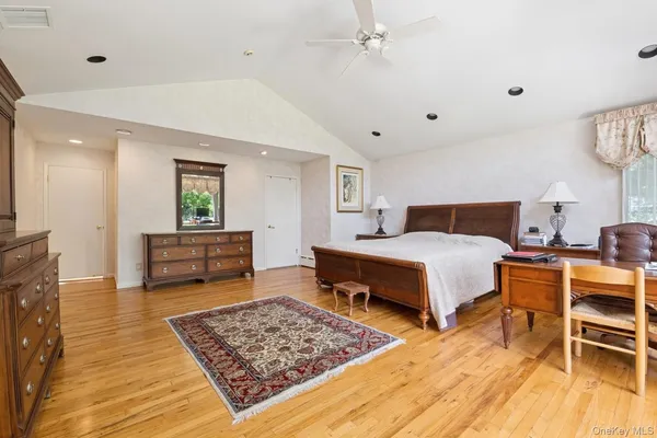 a bedroom with furniture and a rug
