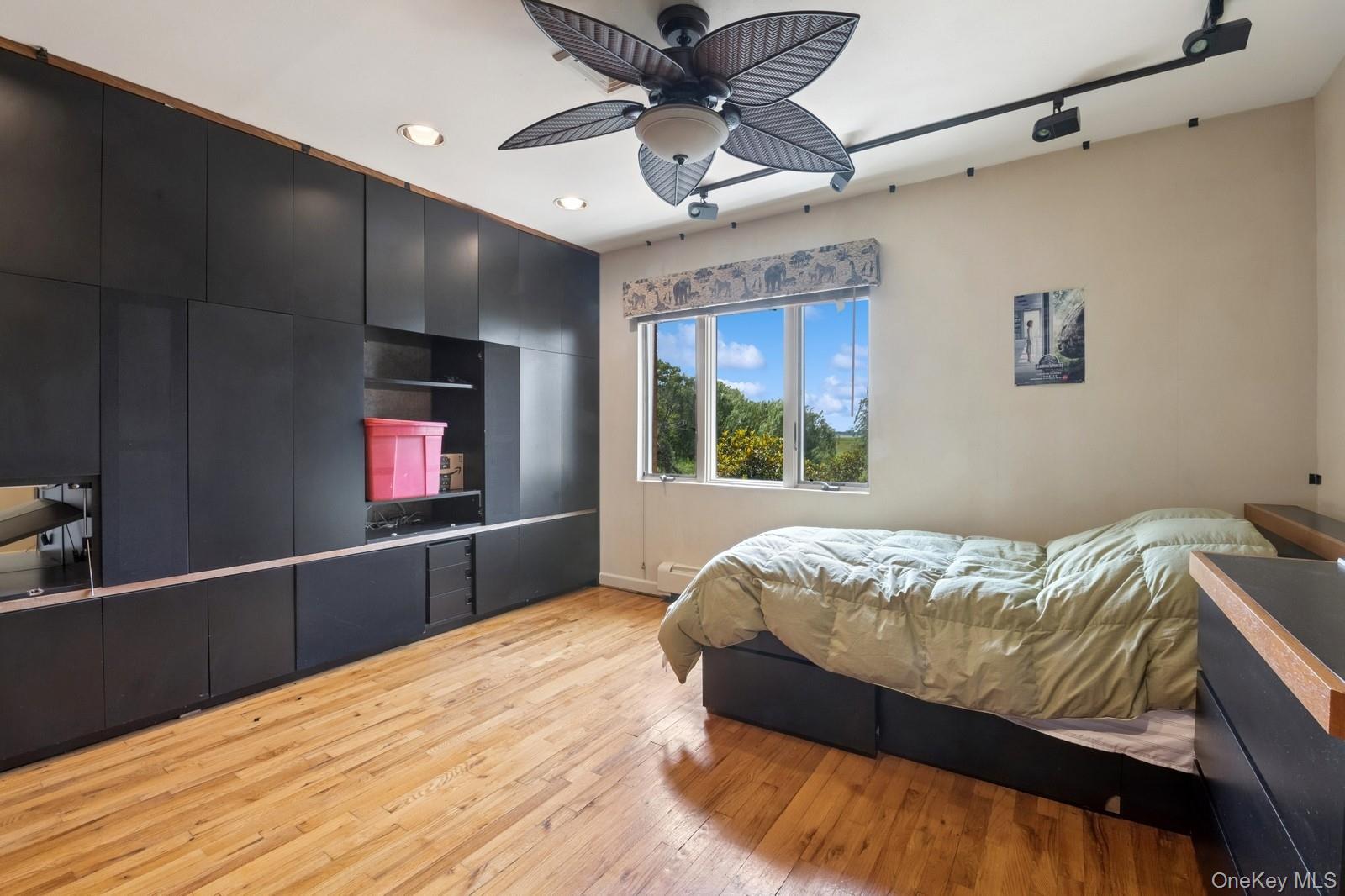 328 Ivy Hill Road Woodmere, NY 11598 - Photo 25 of 37 a bed sitting in a bedroom next to a window