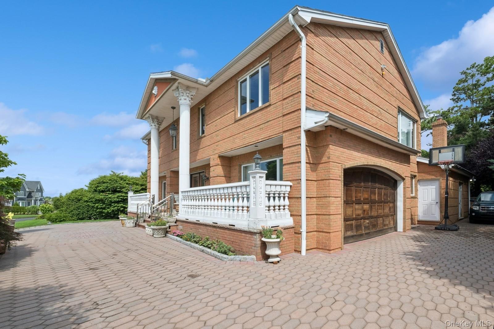 328 Ivy Hill Road Woodmere, NY 11598 - Photo 4 of 37 a front view of a house with a yard
