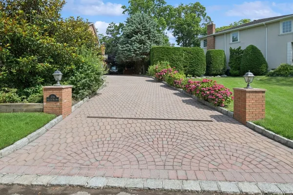 a pathway of a house with a yard