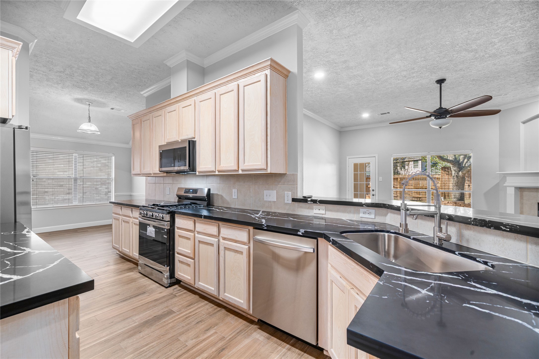 3623 Sage Pointe Court Katy, TX 77449 - Photo 11 of 32 a kitchen with stainless steel appliances granite countertop a sink a stove and cabinets
