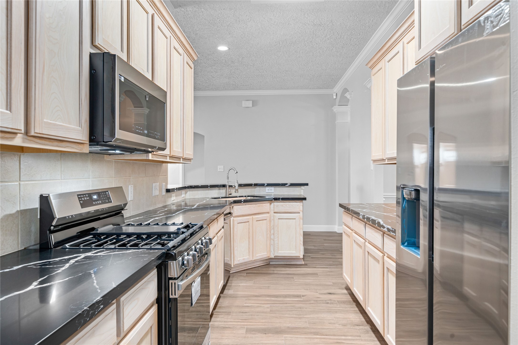 3623 Sage Pointe Court Katy, TX 77449 - Photo 12 of 32 a kitchen with stainless steel appliances granite countertop a stove and a refrigerator