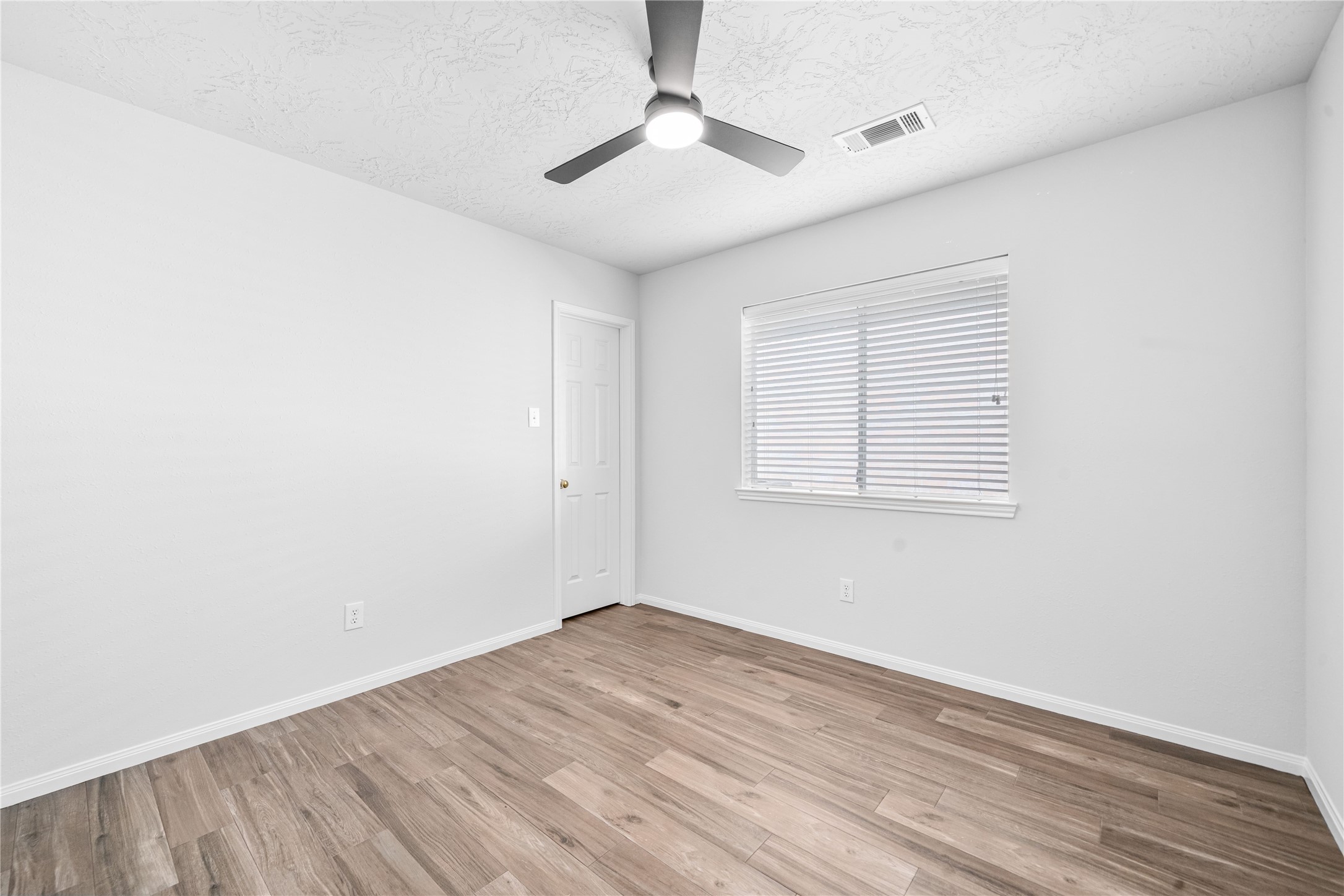 3623 Sage Pointe Court Katy, TX 77449 - Photo 18 of 32 an empty room with a window and a ceiling fan