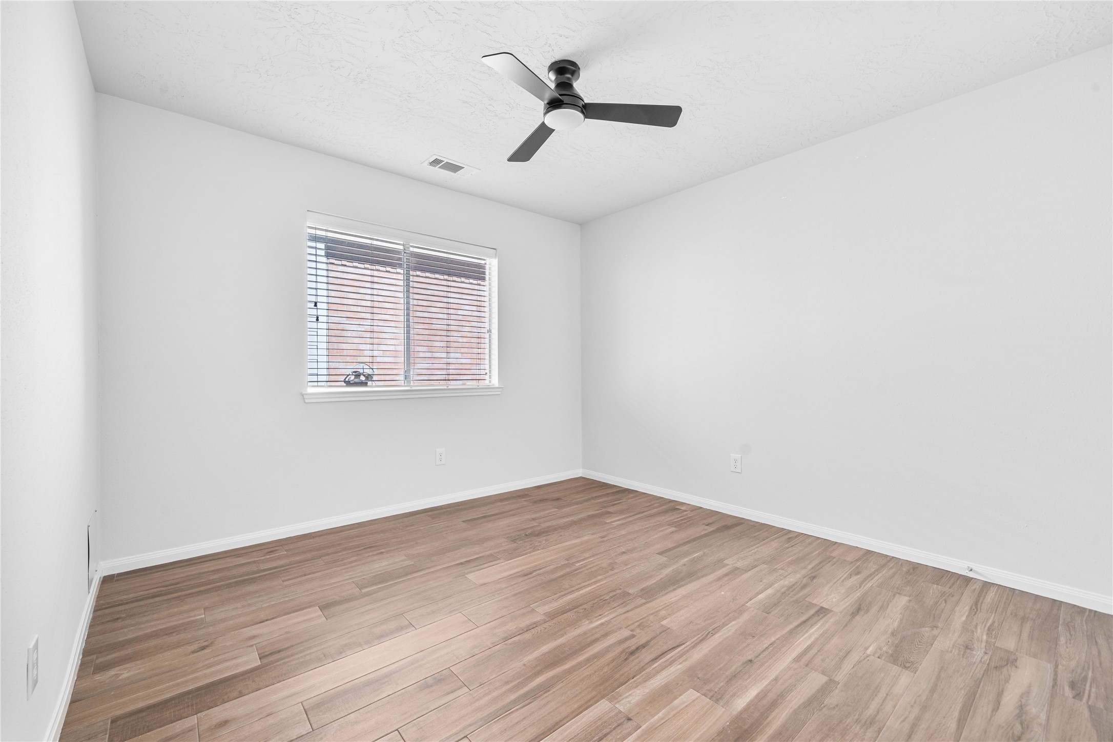 3623 Sage Pointe Court Katy, TX 77449 - Photo 20 of 32 an empty room with wooden floor ceiling fan and windows