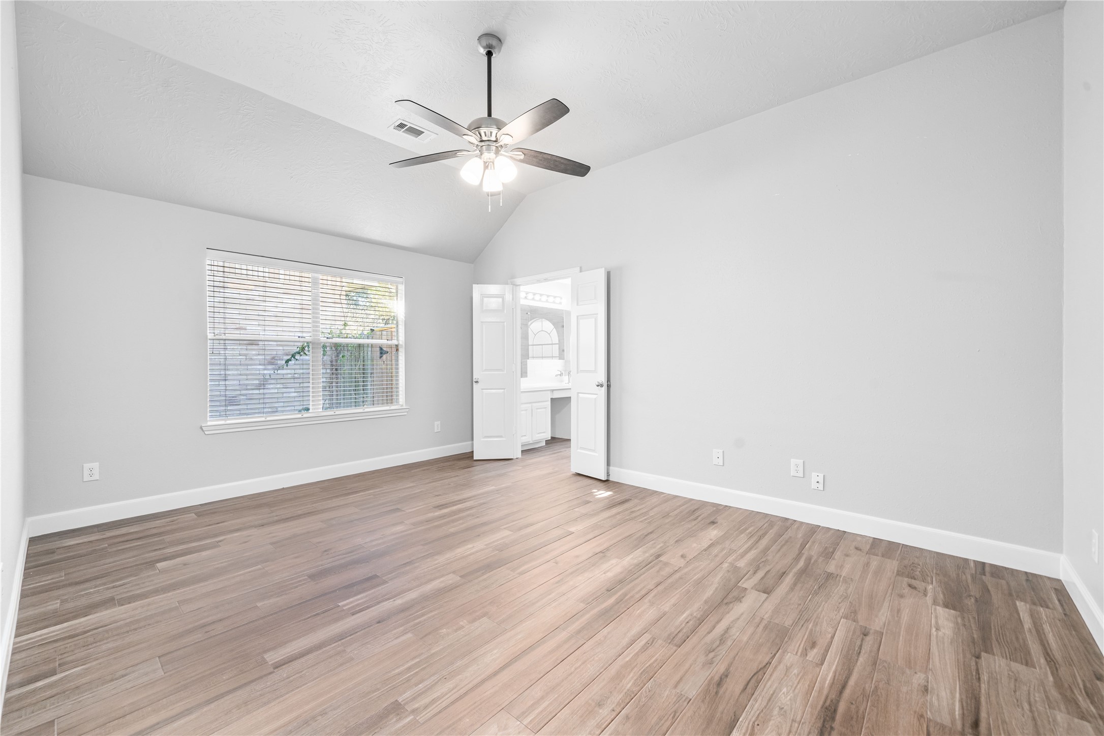 3623 Sage Pointe Court Katy, TX 77449 - Photo 22 of 32 an empty room with wooden floor fan and windows