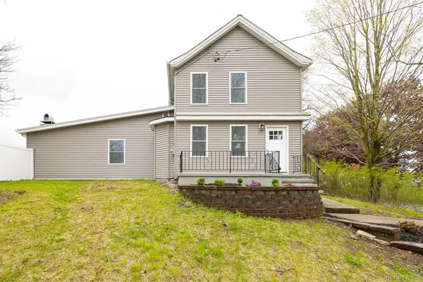 a house that has a big yard in front of it