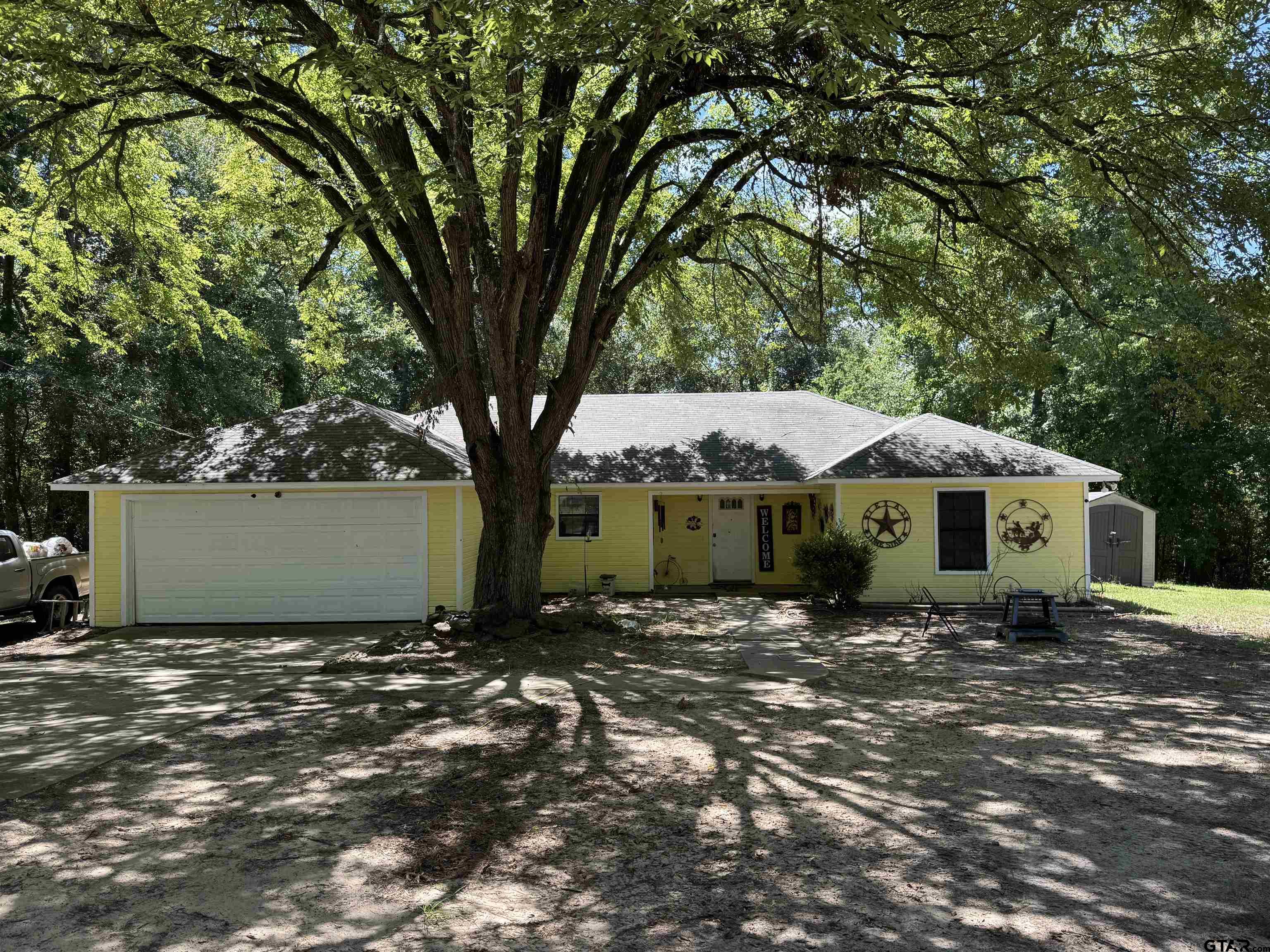 a view of a house with a tree in the background