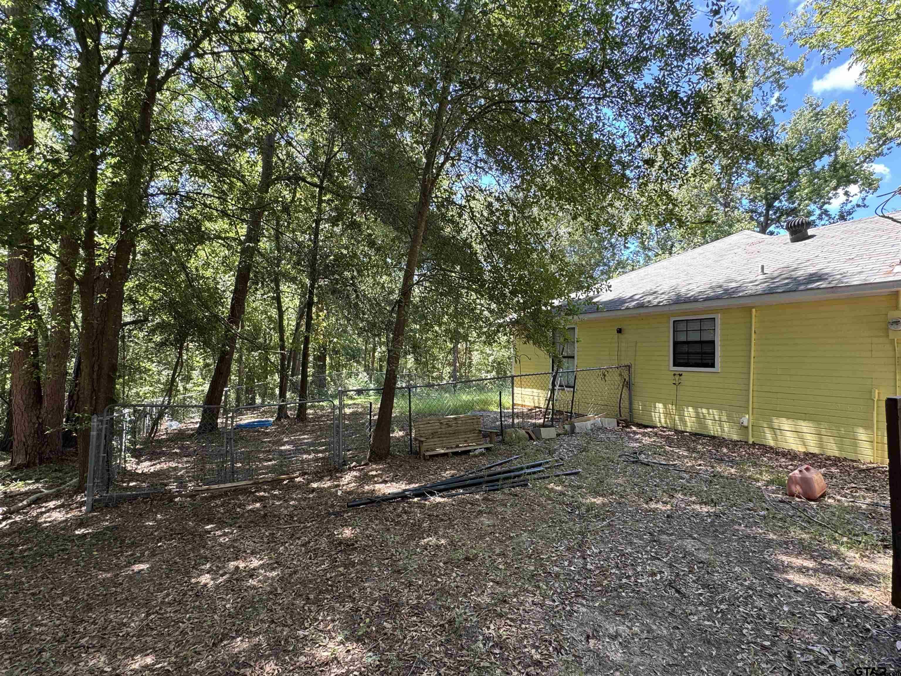 4159 Scrub Pine Road Gilmer, TX 75645 - Photo 13 of 39 a view of a house with a backyard