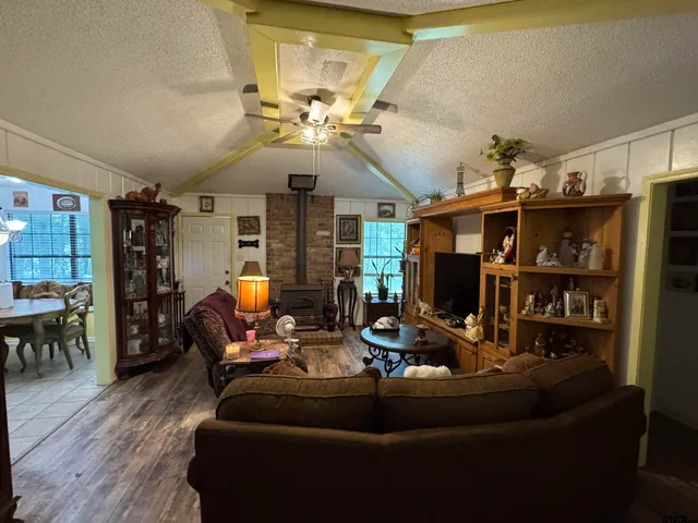 a living room with furniture a dining table and a chandelier