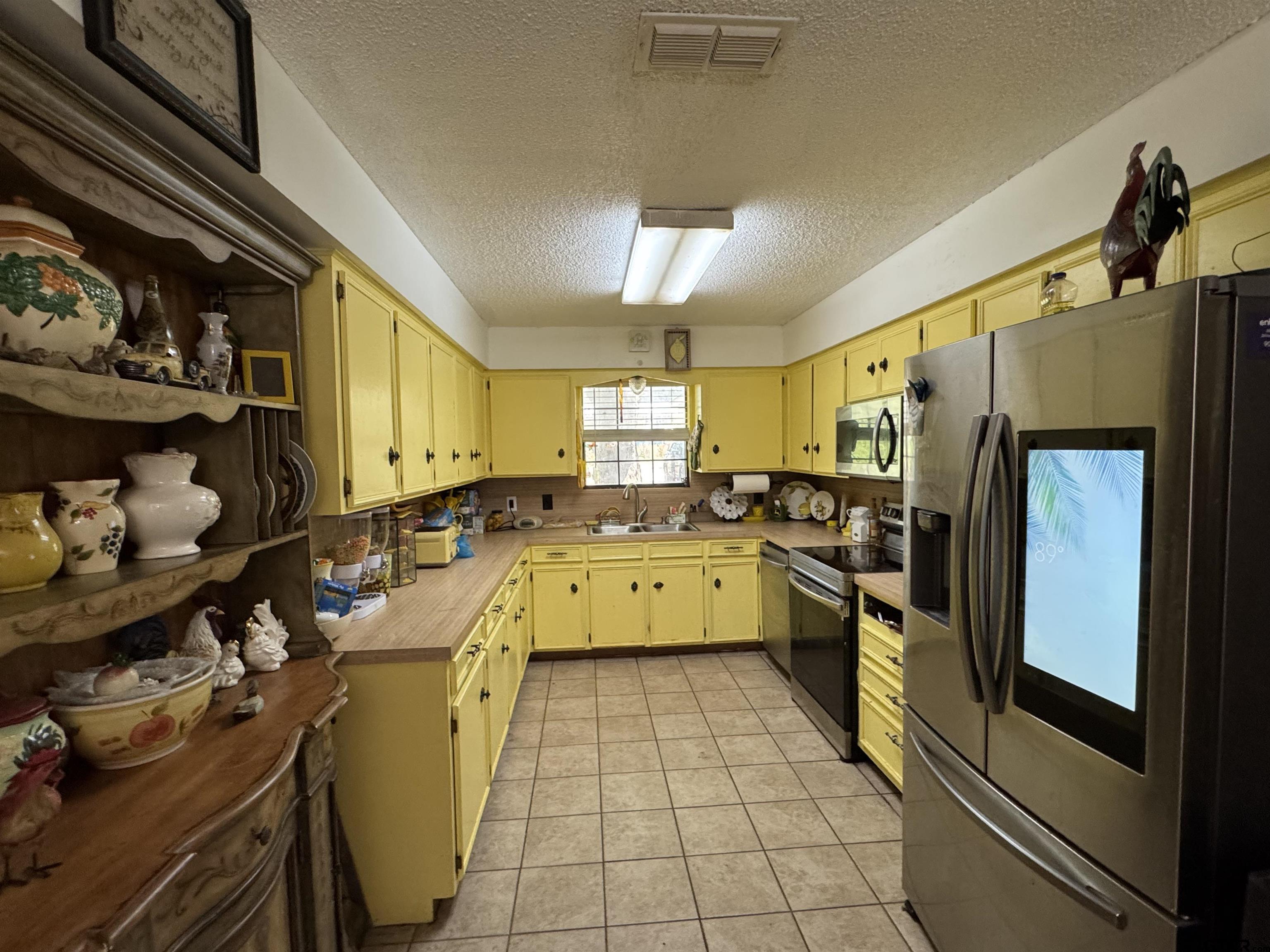 4159 Scrub Pine Road Gilmer, TX 75645 - Photo 20 of 39 a kitchen with a sink appliances and cabinets