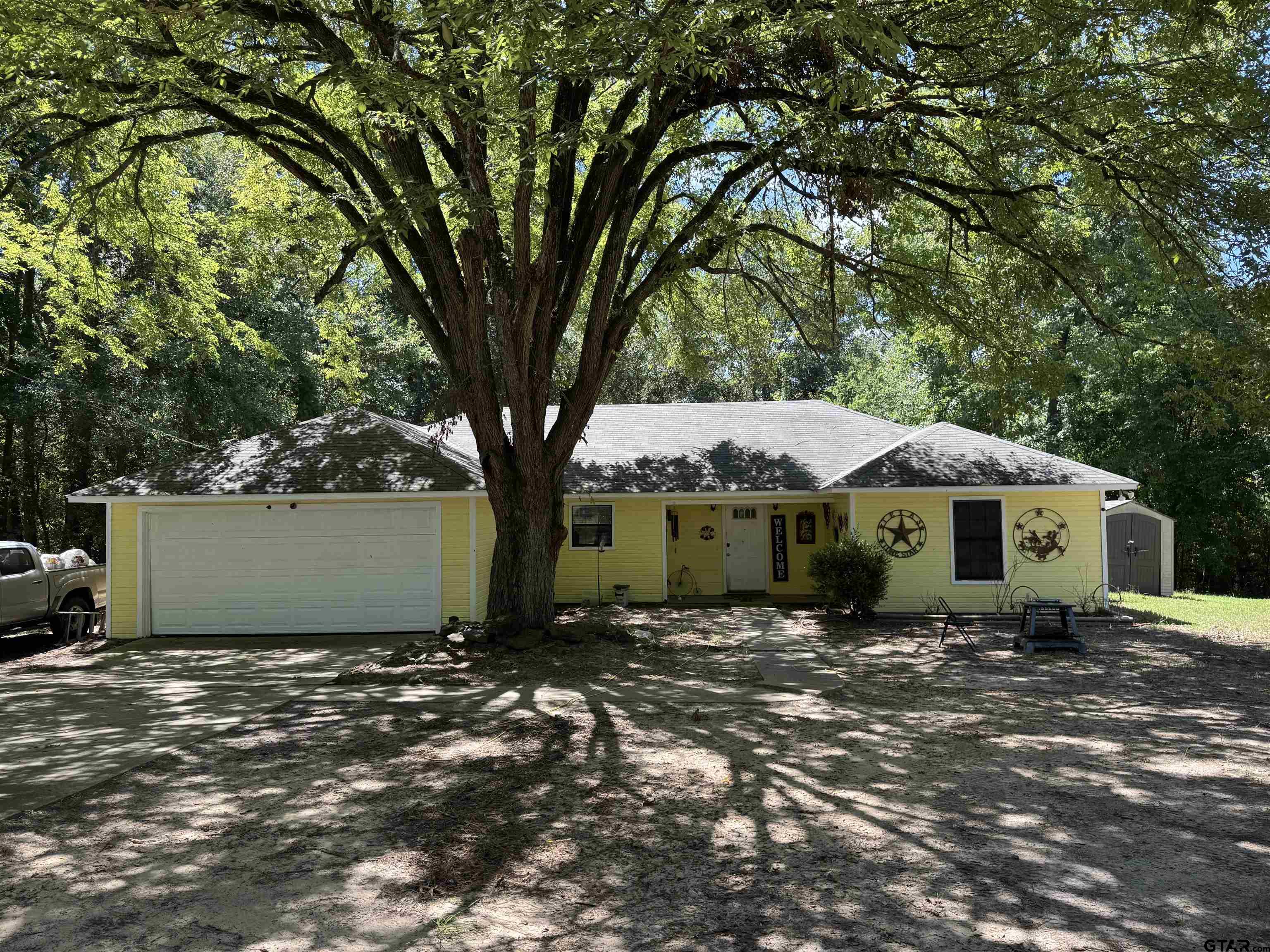 4159 Scrub Pine Road Gilmer, TX 75645 - Photo 2 of 39 a front view of a house with a garden