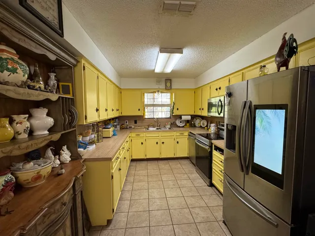 a kitchen with a sink appliances and cabinets
