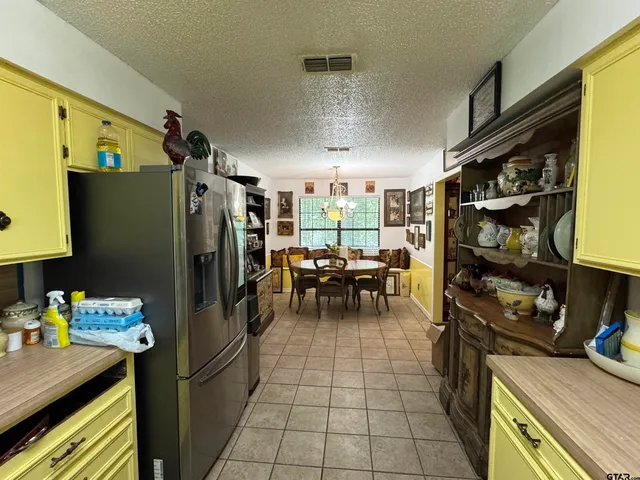 a kitchen with a refrigerator and a table