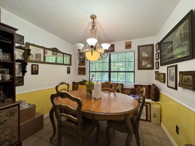 a view of a dining room with furniture and chandelier