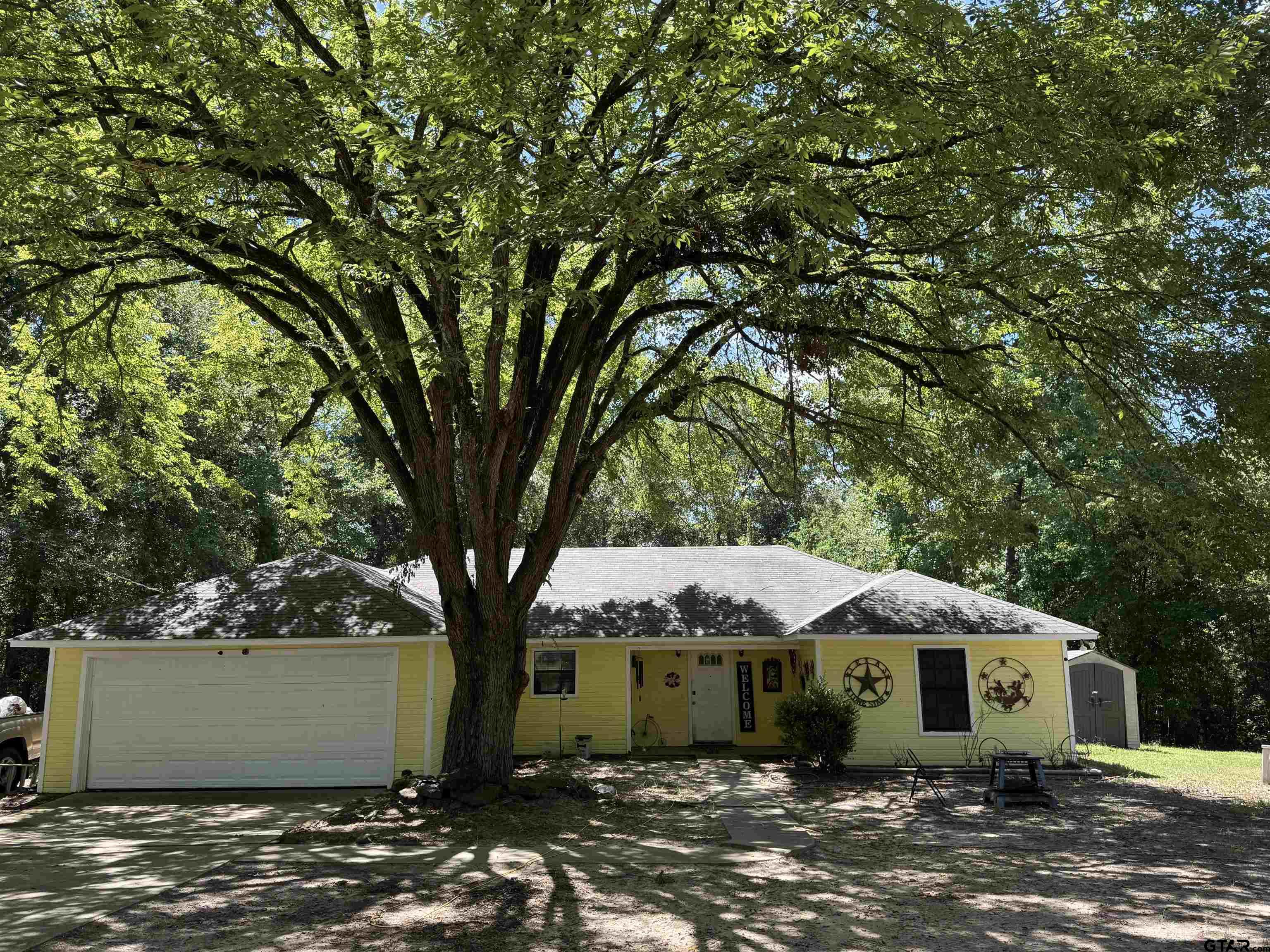 4159 Scrub Pine Road Gilmer, TX 75645 - Photo 3 of 39 a front view of a house with garden