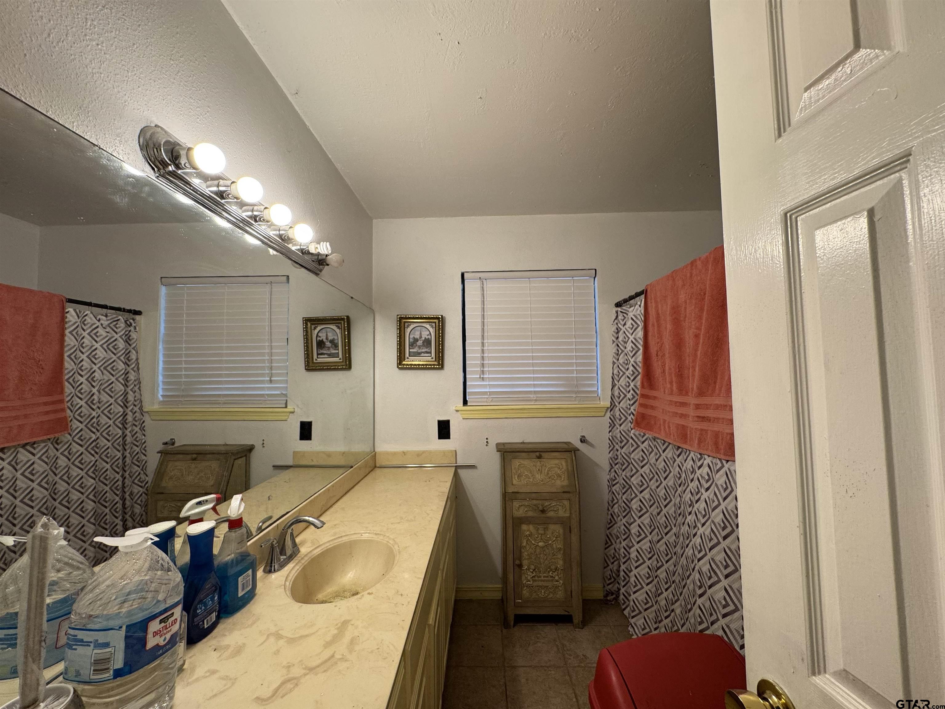 4159 Scrub Pine Road Gilmer, TX 75645 - Photo 31 of 39 a bathroom with a tub sink and mirror