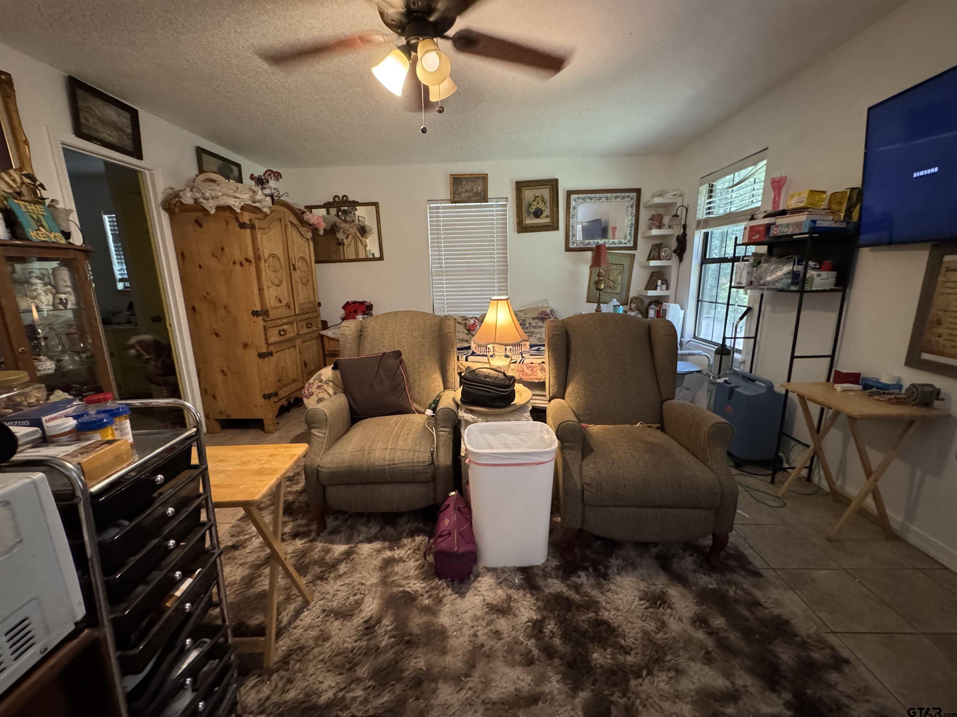 4159 Scrub Pine Road Gilmer, TX 75645 - Photo 34 of 39 a living room with furniture and a flat screen tv