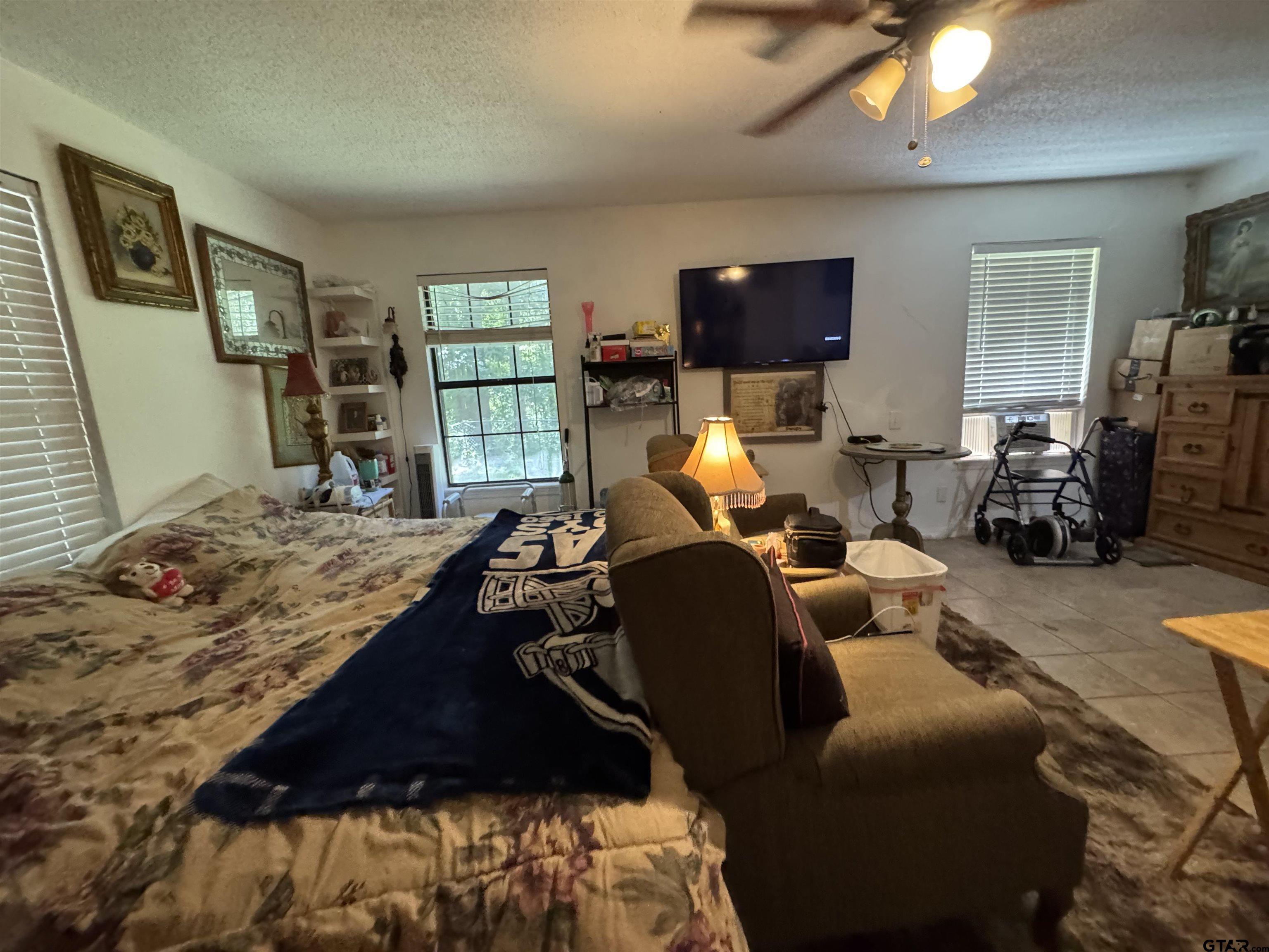 4159 Scrub Pine Road Gilmer, TX 75645 - Photo 36 of 39 a bed room with furniture window and flat screen tv