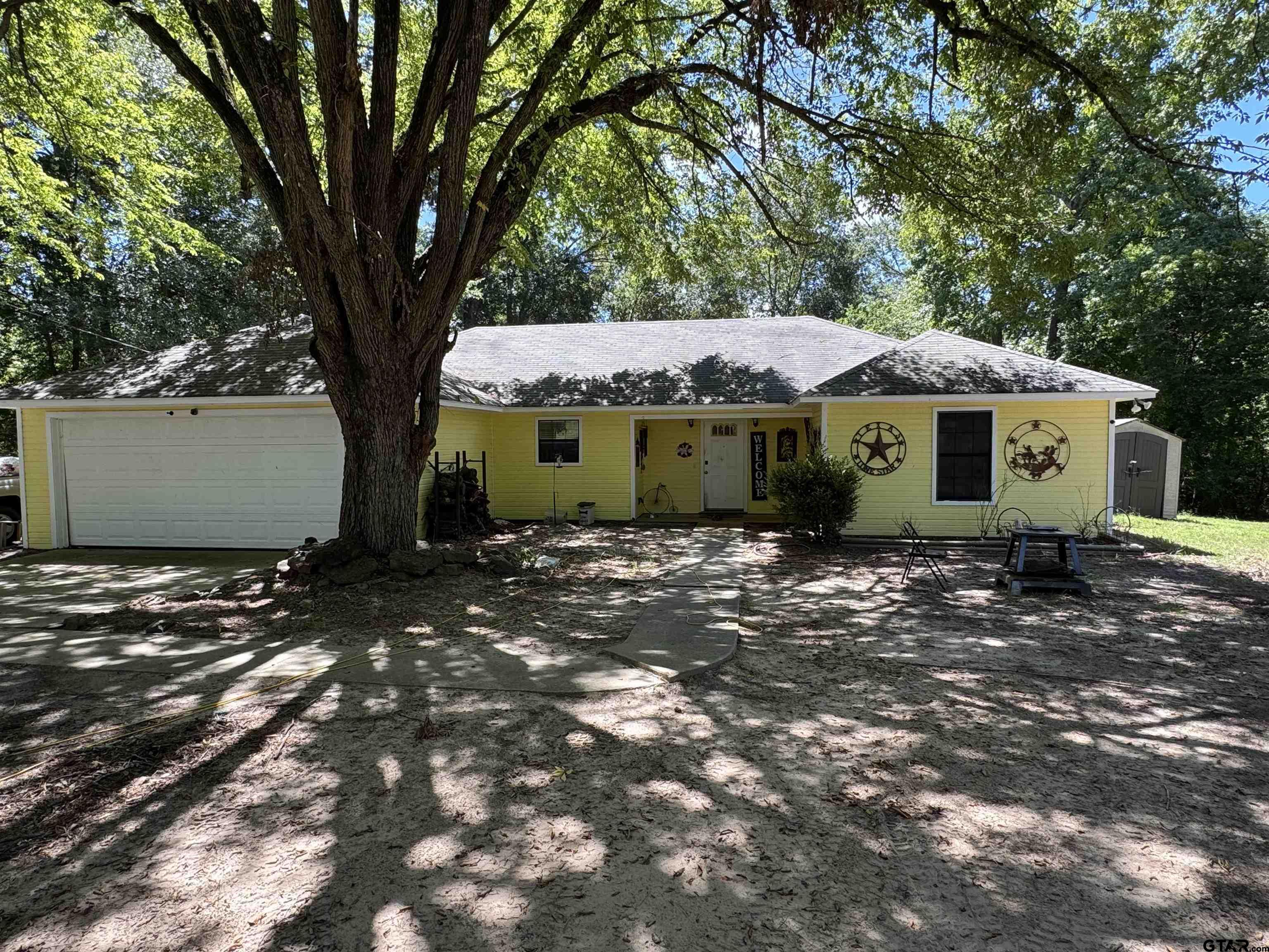 4159 Scrub Pine Road Gilmer, TX 75645 - Photo 4 of 39 a view of a house with a tree and a yard