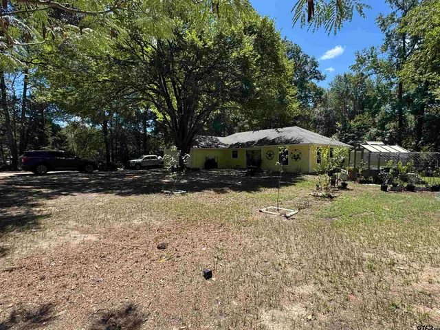 a view of swimming pool and trees in the background