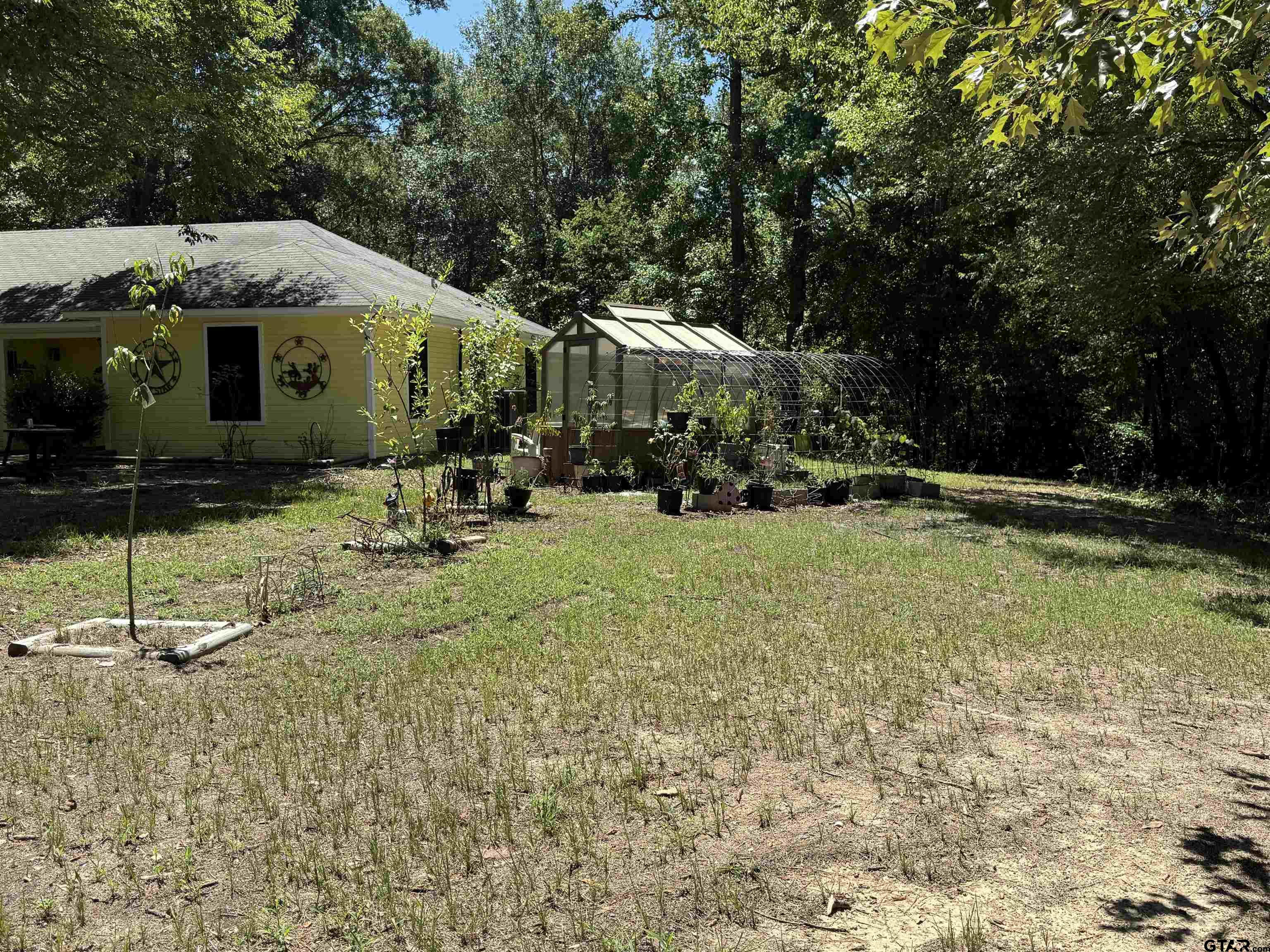 4159 Scrub Pine Road Gilmer, TX 75645 - Photo 9 of 39 a front view of a house with a yard