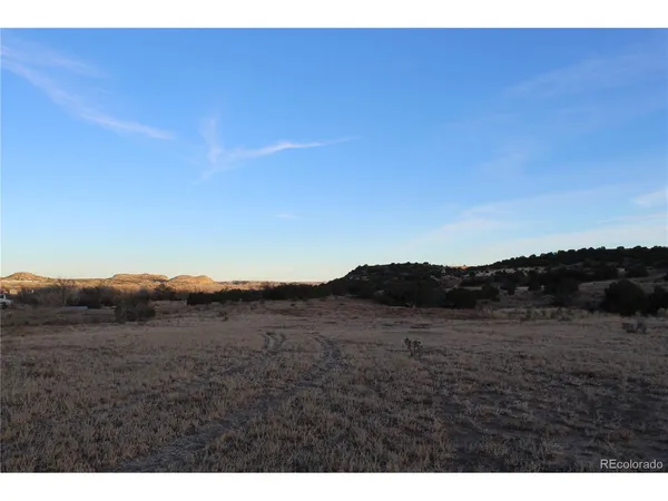 a view of mountain and grassy field