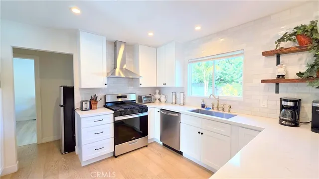 a kitchen with a sink stove and cabinets