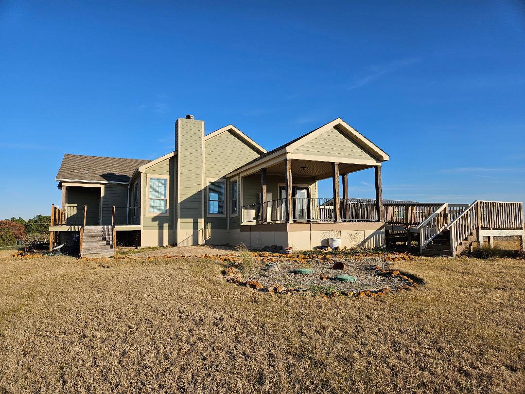 a front view of a house with yard patio and dinning table
