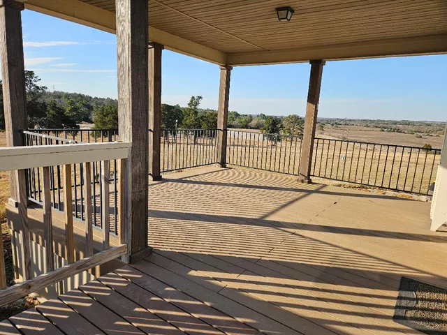 a view of a balcony with a floor to ceiling window next to a road