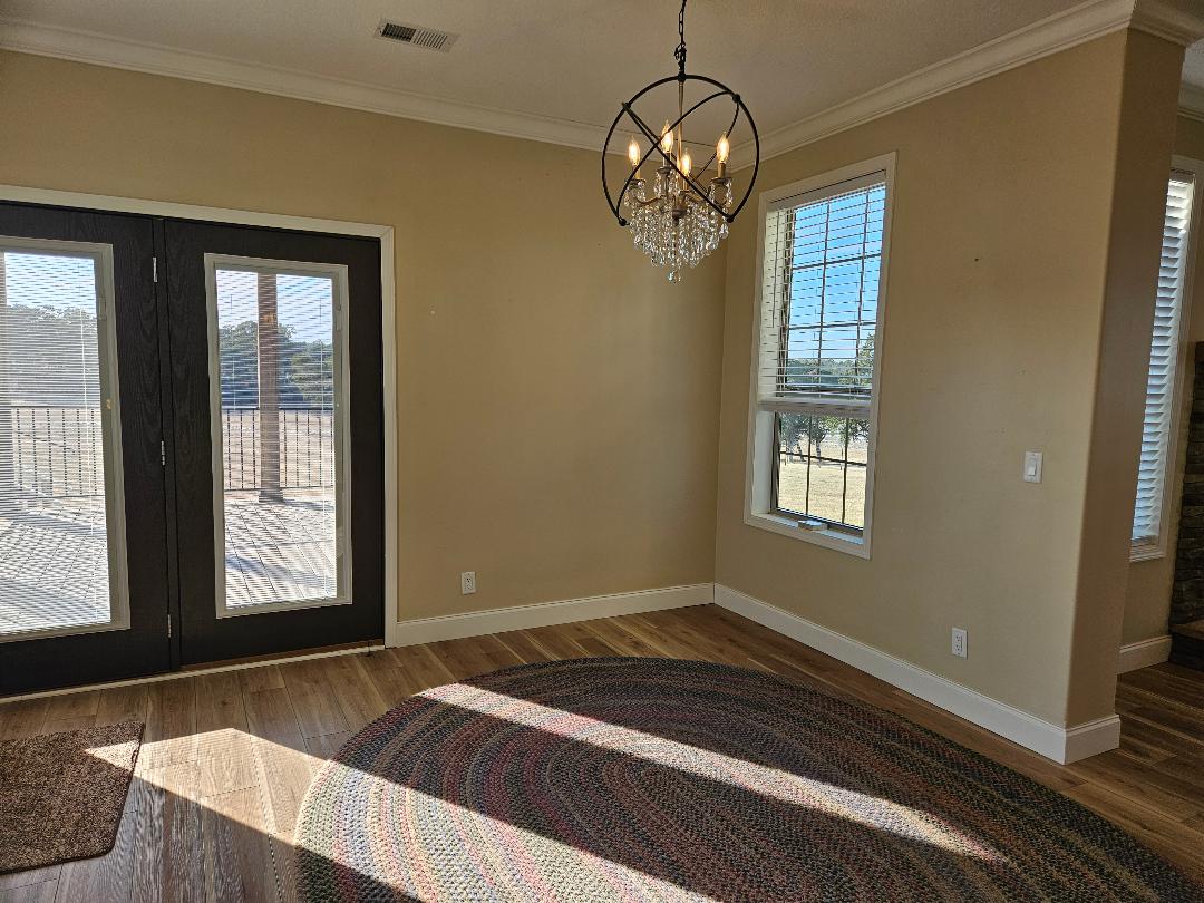 555 Paint Creek Road, Unit C McDade, TX 78650 - Photo 7 of 26 a view of empty room with wooden floor and fan