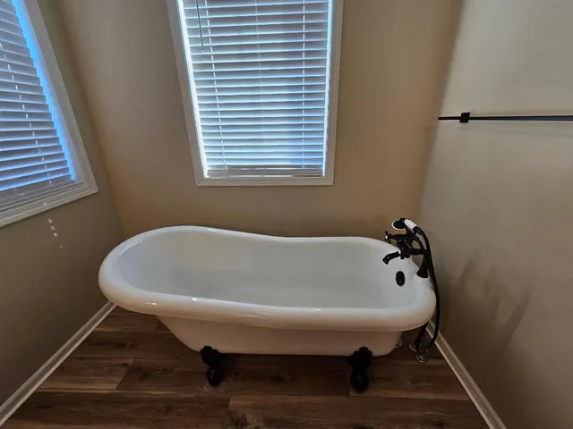 a white bath tub sitting in a bathroom next to a sink