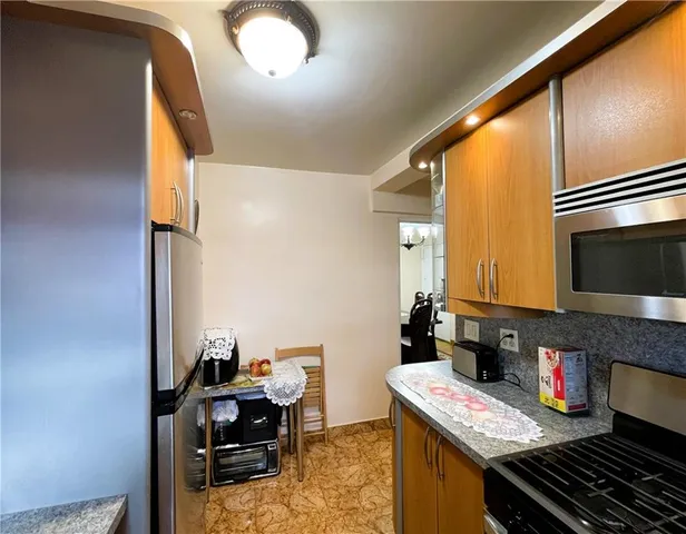 a kitchen with a appliances and cabinets