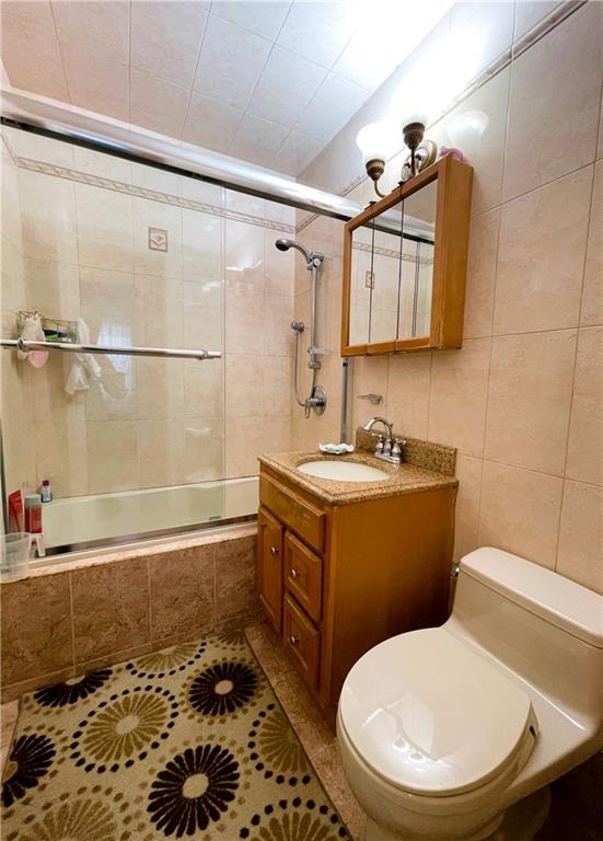 2711 Avenue X, Unit 6J Brooklyn, NY 11235 - Photo 17 of 24 a bathroom with a granite countertop toilet sink and mirror
