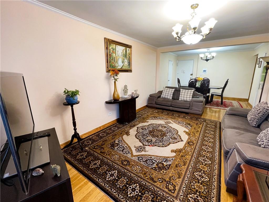 2711 Avenue X, Unit 6J Brooklyn, NY 11235 - Photo 3 of 24 a living room with furniture and a chandelier