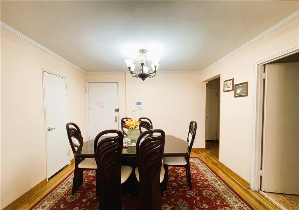2711 Avenue X, Unit 6J Brooklyn, NY 11235 - Photo 6 of 24 a view of a dining room with furniture and chandelier