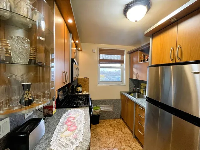 a kitchen with a refrigerator and a stove