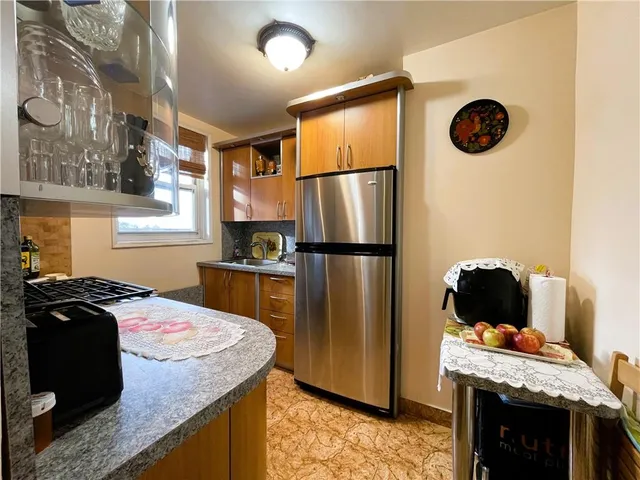 a kitchen with a refrigerator and a stove
