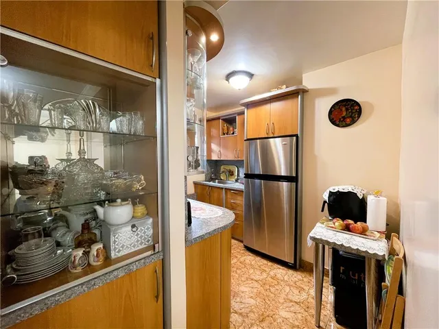 a kitchen with stainless steel appliances granite countertop a refrigerator and a stove
