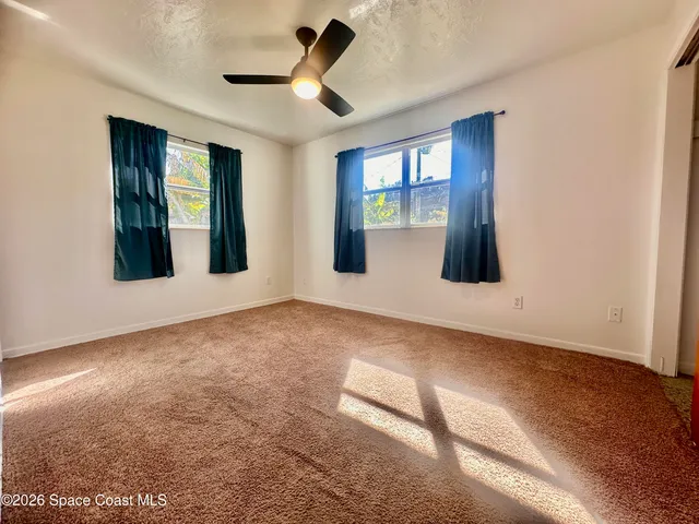a bathroom with a toilet sink vanity and mirror