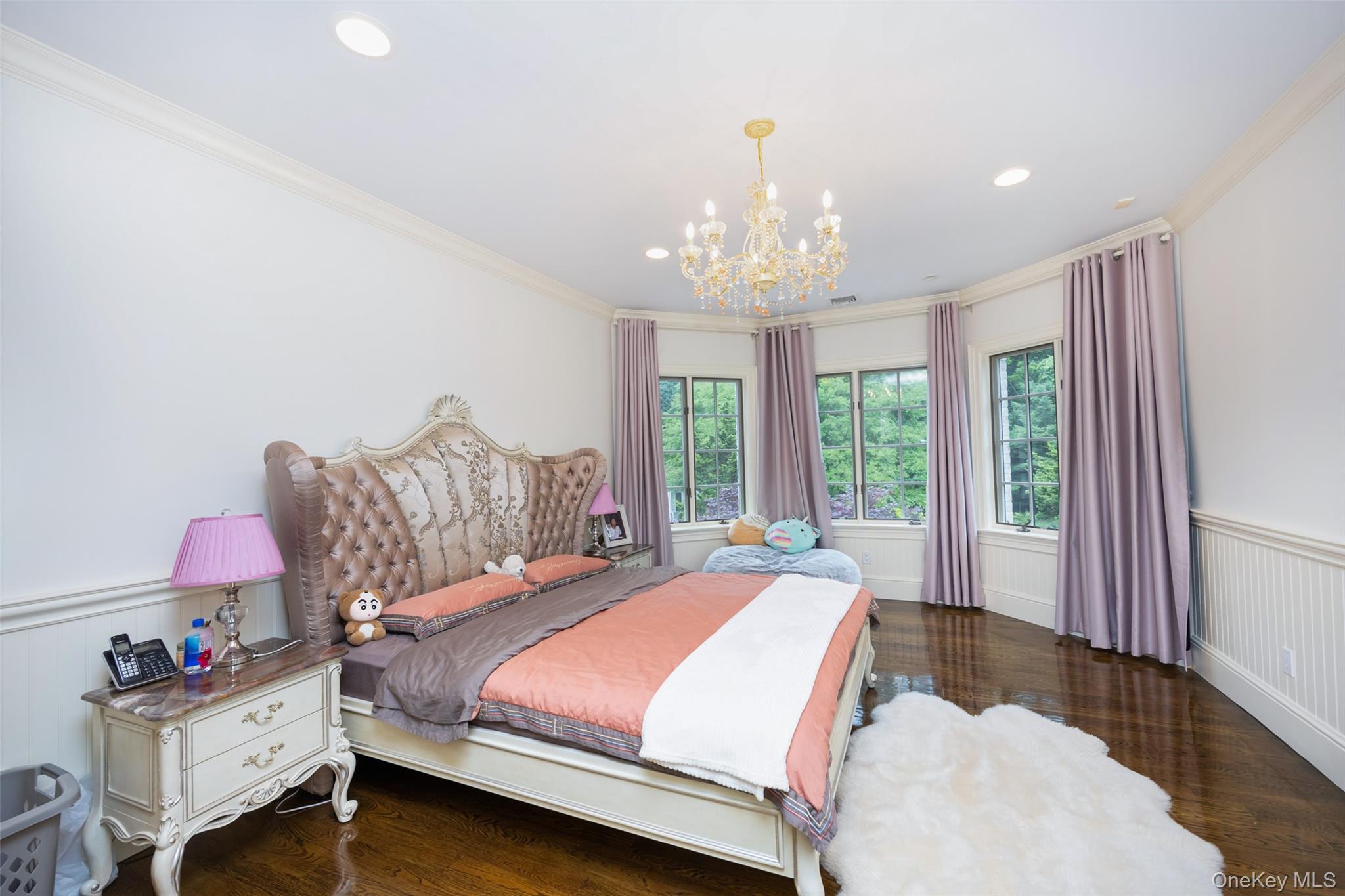 11 Black Rock Road Muttontown, NY 11545 - Photo 25 of 45 a spacious bedroom with a bed and a chandelier