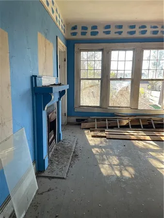a living room with a fireplace and a window