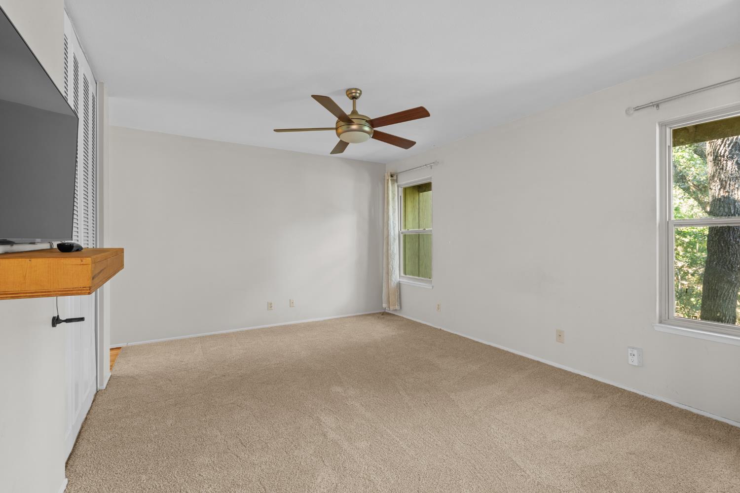 6909 Monticello Court Citrus Heights, CA 95621 - Photo 23 of 38 an empty room with windows and a ceiling fan