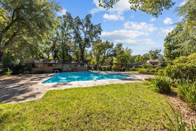 a view of a swimming pool with an outdoor space and seating area