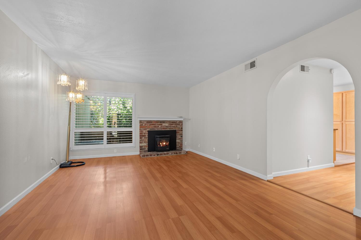 6909 Monticello Court Citrus Heights, CA 95621 - Photo 8 of 38 a view of empty room with wooden floor and fireplace