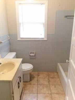 3405 24th Street Lubbock, TX 79410 - Photo 8 of 11 a bathroom with a sink a toilet and a window