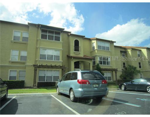 5144 Conroy Road, Unit 1034 Orlando, FL 32811 - Photo 1 of 1 a front view of a house with a garden